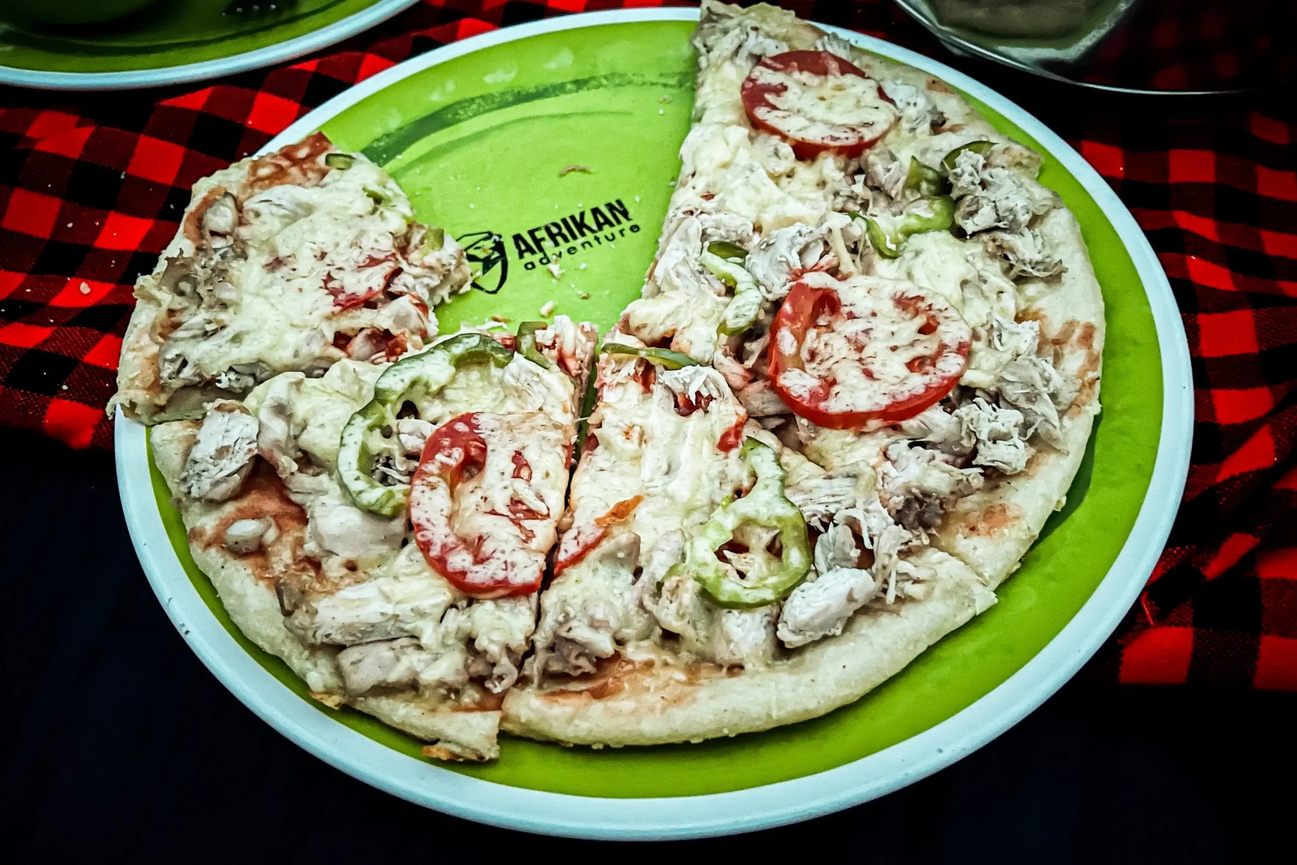 A plate full of sliced pizza provided as food to our travelers in between treks and safari