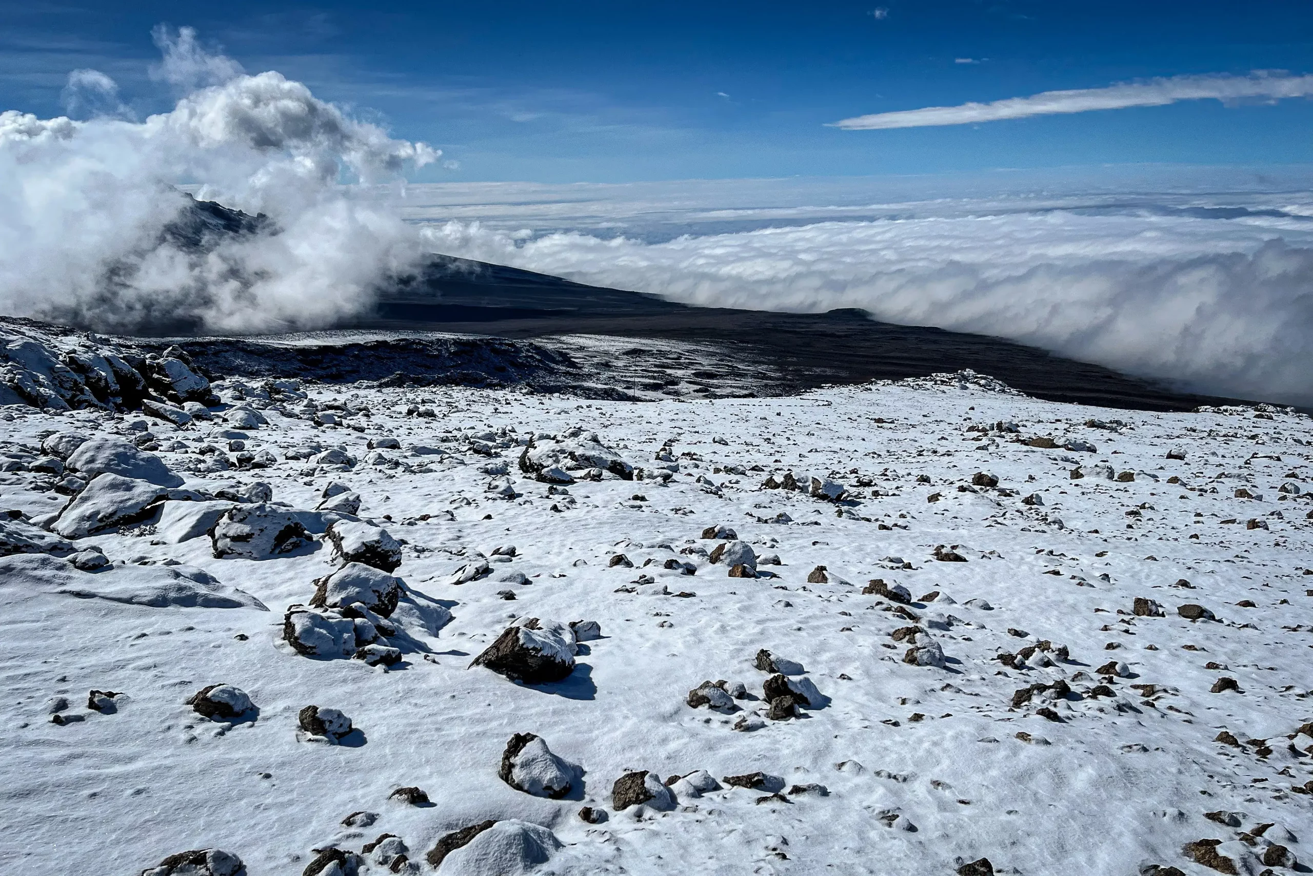 the magnificent view of snow and clouds at Kilimanjaro peak after trekking for 5 days
