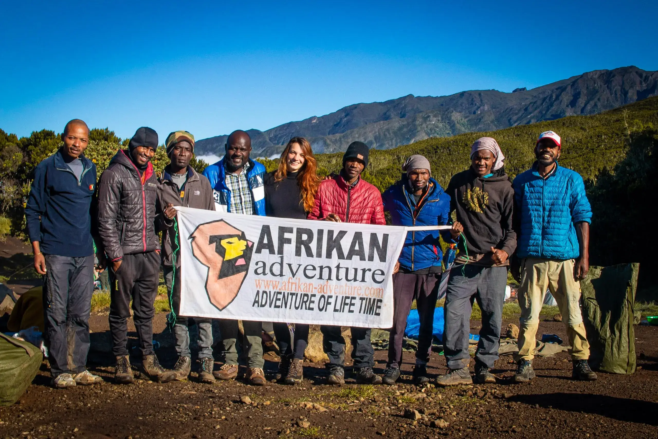 Our travelers, who are a group of friends taking a picture after completing Kilimanjaro trek