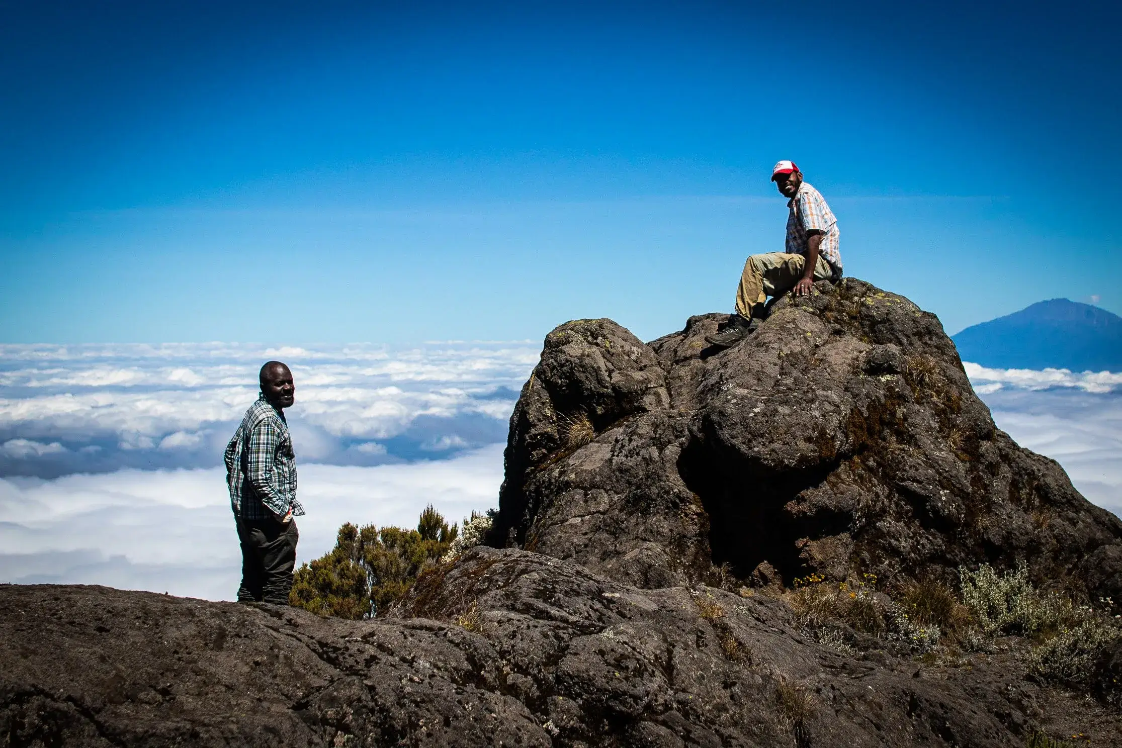 Our Adventurous travelers having moments of joy after reaching the highest point of Kilimanjaro