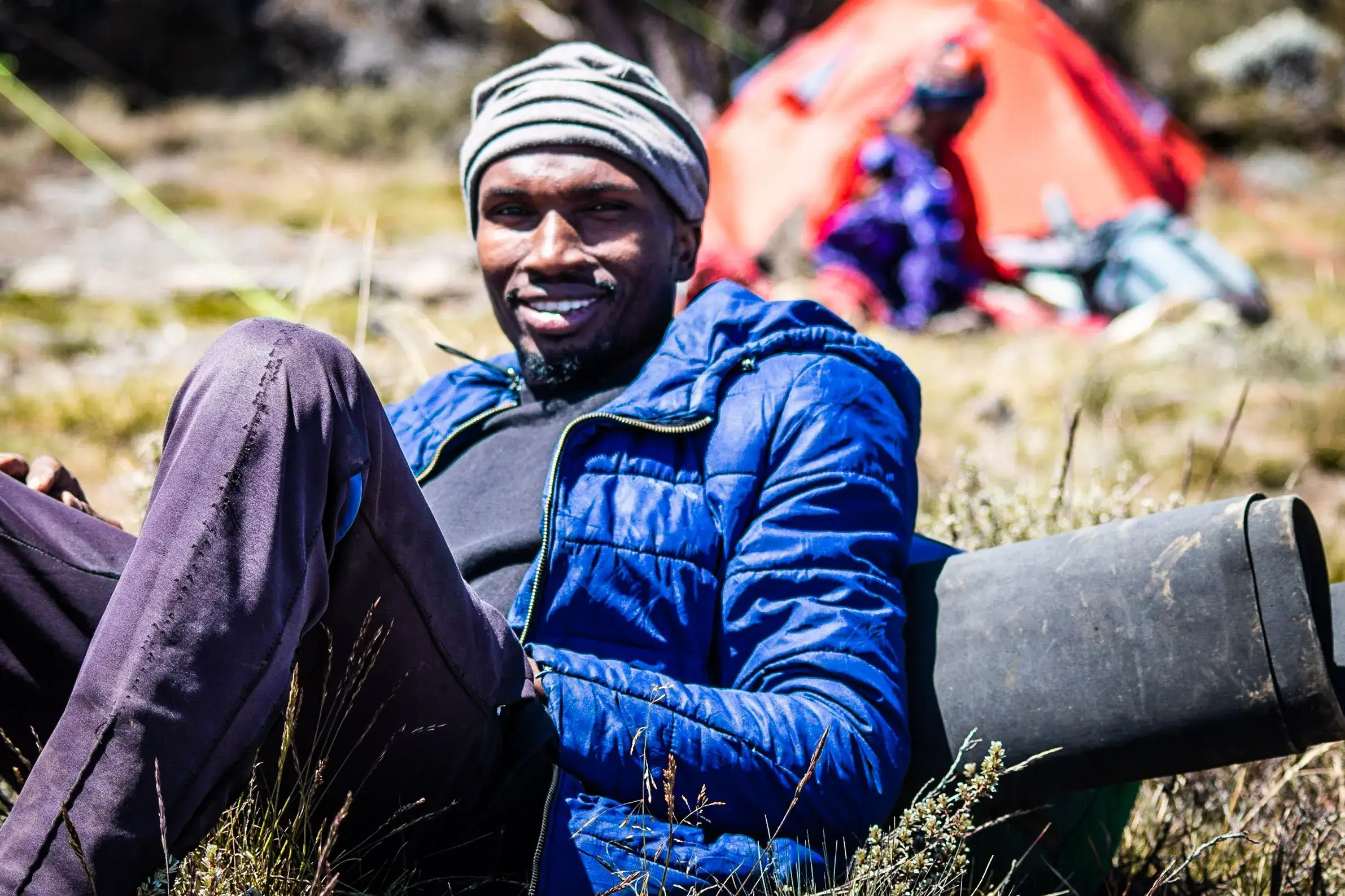 Afrikan adventures porter who is helping the trekkers to complete their summit